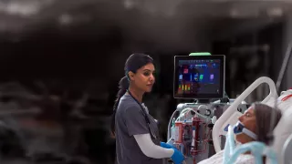 Clinician using the PrisMax system at the bedside
