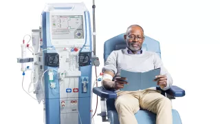 Male-patient-on-Artis-Physio-Plus-reading-a-book