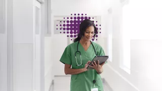 Nurse in green shirt looking at screen - purple