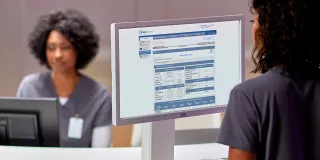 Woman on laptop viewing Sharesource remote patient management