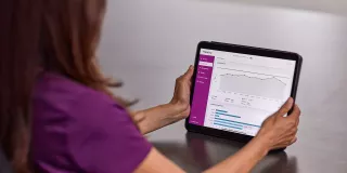 nurse with tablet in hands on table 