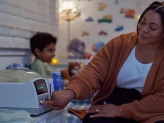 Woman preparing treatment for son in bedroom