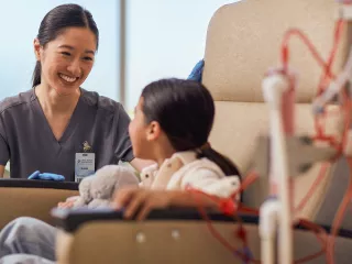 Female healthcare professional giving treatment to child