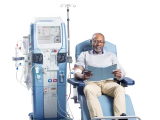 Male-patient-on-Artis-Physio-Plus-reading-a-book