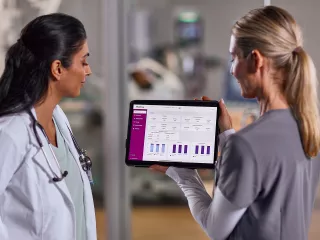 Two nurses looking at tablet