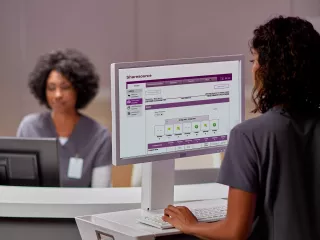 two nurses sitting at their computer station